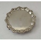 RICHARD RUGG An 18th century silver salver, scallop and gadrooned rim, on three feet, London 1762,