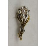 A 9CT GOLD BROOCH, modelled as a bunch of flowers, in the Victorian manner, inset six pearls and