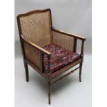 A LATE 19TH / EARLY 20TH CENTURY MAHOGANY FINISHED BEECH FRAMED BERGERE in the manner of Gillows,