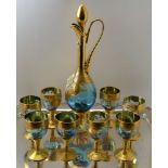 A 20TH CENTURY BOHEMIAN GLASS WINE DECANTER AND A SET OF EIGHT STEMMED GLASSES, blue tinted, heavily