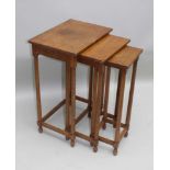 A 1930s ENGLISH ARTS & CRAFTS QUARTER SAWN OAK NEST OF THREE TABLES, on plain turned legs, 72cm x