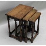 A WELL MADE REPRODUCTION OAK FINISHED NEST OF THREE TABLES, on plain turned and blocked legs, the