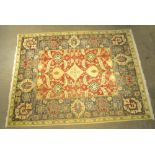 A HAND WOVEN INDIAN CARPET of stylised floral design
