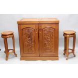 A CONTEMPORARY ORIENTAL DESIGN HARDWOOD HOME BAR UNIT, the two carved panelled doors opening to