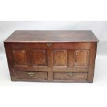 A 19TH CENTURY OAK MULE CHEST having box top, lift-up lid, over four plain panelled frontage, with