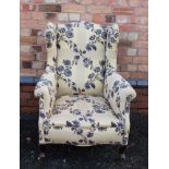 A GEORGIAN DESIGN WING BACK DEEP SEATED ARMCHAIR, in a modern floral design upholstery, having