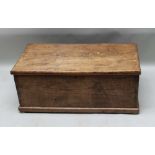 A 19TH CENTURY ELM BLANKET BOX of plain form, the lift-up lid revealing candle box interior,