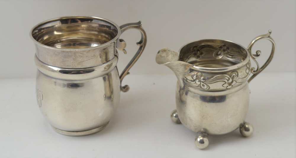 AN ART NOUVEAU SILVER CREAM JUG Birmingham 1903 together with a silver Christening mug, Birmingham