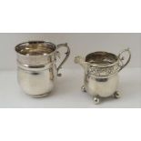 AN ART NOUVEAU SILVER CREAM JUG Birmingham 1903 together with a silver Christening mug, Birmingham