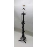 A FIRST QUARTER 20TH CENTURY BLACK FINISHED IRON WORK STANDARD LAMP, the scrolling frame having