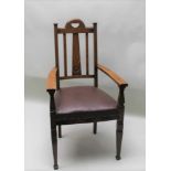 A LATE 19TH / EARLY 20TH CENTURY ARTS & CRAFTS OAK ARMCHAIR with slatted back, rexine overstuffed