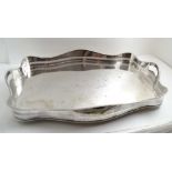 A SILVER PLATED SERPENTINE GALLERY TEA TRAY, two pierced handles in the gadrooned gallery, 61.5cm