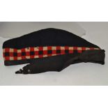 THE ROYAL SCOTS' MILITARY TUNIC JACKET AND REGIMENTAL TARTAN TREWS, together with a peak cap,