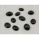 A BAG OF TEN CATSEYE POLISHED JEWELLERS CABOCHONS, 2cm x 1.5cm