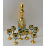 A 20TH CENTURY BOHEMIAN GLASS LIQUOR DECANTER AND A SET OF EIGHT STEMMED GLASSES, blue tinted,