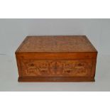 AN ASIAN HARDWOOD PARQUETRY DECORATED STORAGE TABLE CASKET, the hinged lid, opening to reveal