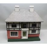 A MID 20TH CENTURY MOCK TUDOR DESIGN DOLL'S HOUSE, 80cm high (inclusive of chimney), 80cm wide, on a