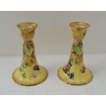 A PAIR OF ROYAL WORCESTER BONE CHINA CANDLESTICKS, hand painted fruit decoration, signed by J.