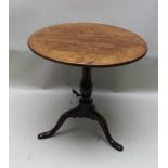 A 19TH CENTURY OAK CIRCULAR SNAP TOP TABLE supported on plain baluster column and three downswept