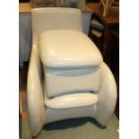 A MODERNIST IVORY LEATHER EFFECT UPHOLSTERED DEEP SEATED ARMCHAIR with foot stool en suite