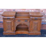 AN ART NOUVEAU DESIGN OAK SIDEBOARD, twin pedestal design, with carved panel decoration, fitter