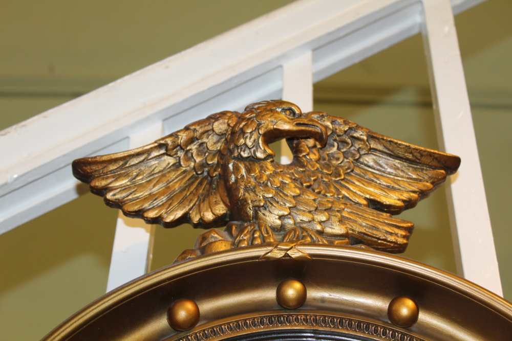 A REGENCY DESIGN GILT FRAMED CONVEX WALL MIRROR with ball frame and eagle crest, plate size; 28cm - Image 2 of 2