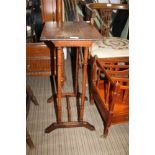 A CARVED WOODEN TOPPED OCCASIONAL TABLE, on ring turned supports