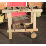 A WELL WEATHERED TEAK ALFRESCO TROLLEY with slide out serving trays, glass hangers, bottle caddies