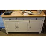 A LAURA ASHLEY SIDEBOARD having light oak effect top over three inline drawers, and three cupboard