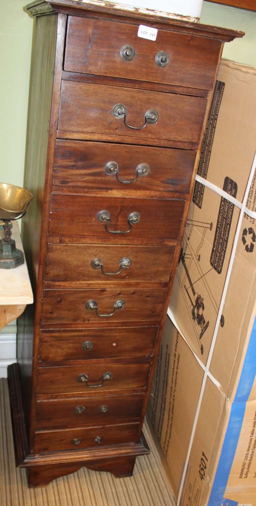 AN IMPORTED MAHOGANY COLOURED TALL CHEST OF TEN DRAWERS