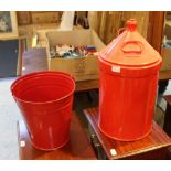 A RED PAINTED FUEL CONTAINER AND A FIRE BUCKET