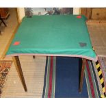 A BAIZE TOP FOLDING CARD TABLE with extra loose cover