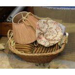 A DECORATIVE OVAL BASKET CONTAINING INTERIOR FURNISHING ITEMS, cushions, tie-backs, light shade,