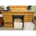 A MODERN PINE TWIN PEDESTAL DESK of typical form and construction