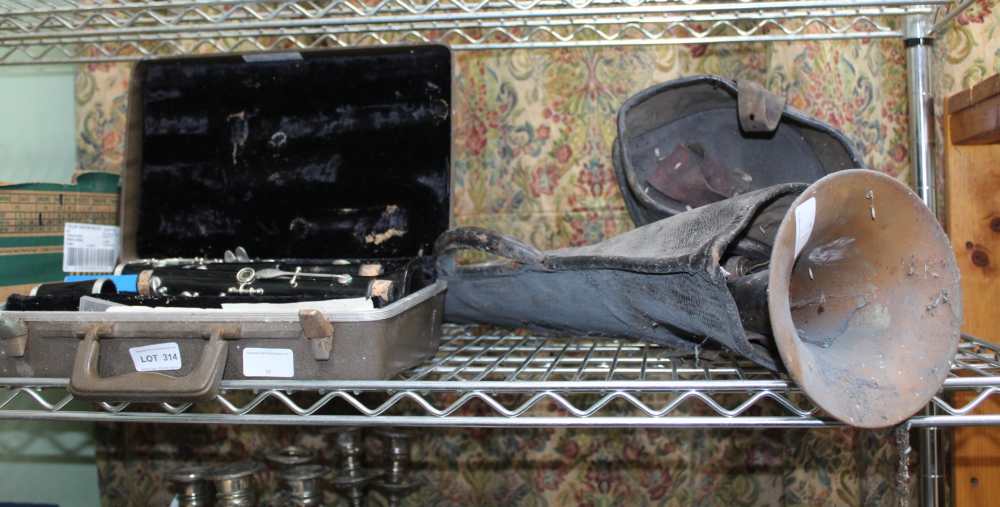 A CASED CLARINET AND A VINTAGE TROMBONE in remains of pigskin case