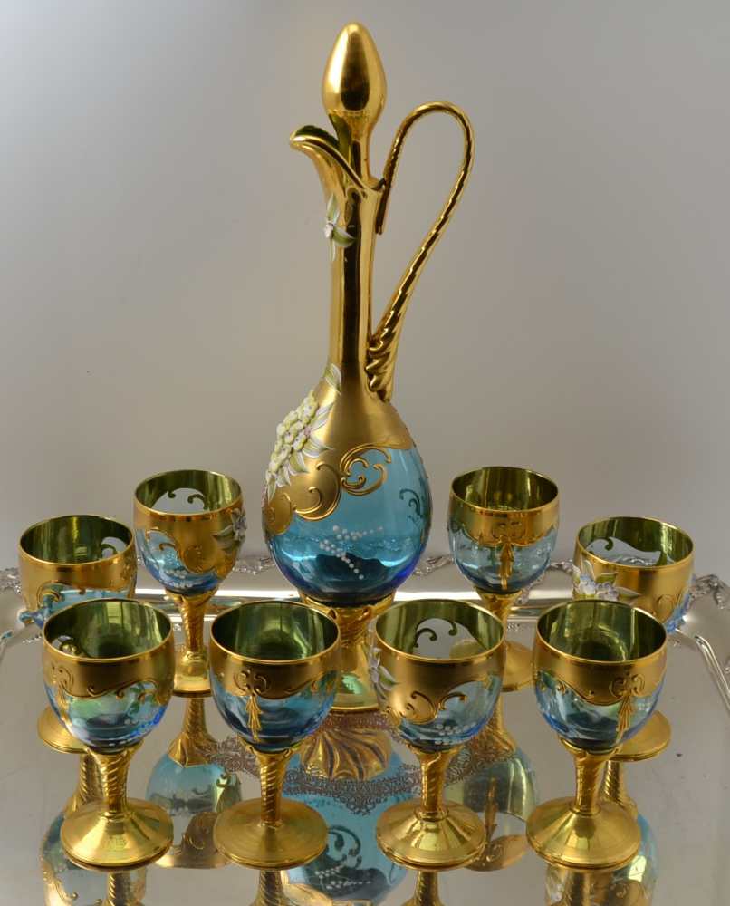 A 20TH CENTURY BOHEMIAN GLASS WINE DECANTER AND A SET OF EIGHT STEMMED GLASSES, blue tinted, heavily