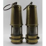 A PAIR OF NOVELTY BOOKENDS , fashioned from a brass miners safety lamp, 27cm high