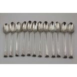 A SET OF TWELVE SILVER DESSERT SPOONS, Onslow pattern, crested, London 1764, combined weight; 408g