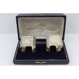 LANSON LTD. A CASED PAIR OF SILVER ART DECO DESIGN NAPKIN RINGS, Birmingham 1936 and 1938,