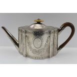 BENJAMIN MONTAGUE, AN 18TH CENTURY OVAL SILVER TEAPOT, of serpentine form, with hinged cover, bright