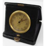 A 'MAPPIN & WEBB' TRAVEL CLOCK, housed in a black leather folding case, the circular dial with