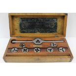 A WOODEN CASED TAP AND DIE SET, 'Morse Twist Drill and Machine Co. of New Bedford, Massachusetts,