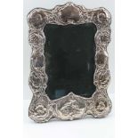 A VICTORIAN DESIGN SILVER MOUNTED PHOTOGRAPH FRAME, embossed cherub decoration, overall 32cm x 22cm,