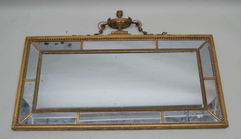A 19TH CENTURY GILT FRAMED MULTI-PANELLED MIRROR with beaded divides and scalloped frame, of