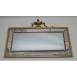 A 19TH CENTURY GILT FRAMED MULTI-PANELLED MIRROR with beaded divides and scalloped frame, of