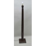 A MAHOGANY FINISHED STANDARD LAMP formed from a spiral fluted bed post, on a later stepped square