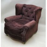 A 20TH CENTURY EXTRA DEEP SEATED ARMCHAIR reminiscent in proportions to 'Howard', having low