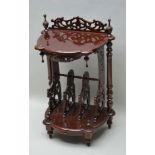 A 20TH CENTURY MAHOGANY FINISHED TWO-TIER CANTERBURY STYLE UNIT, with sectional fret work carved