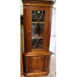 A LATE 20TH CENTURY MAHOGANY COLOURED WOOD CORNER UNIT the astraglazed up section supported on a