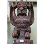 A CARVED WOOD INDIAN DEITY of Avian form